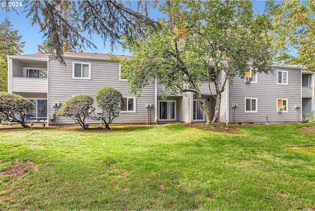 rear view of property with a lawn