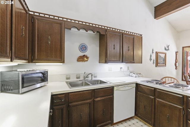 kitchen featuring vaulted ceiling with beams, white appliances, dark brown cabinetry, and sink