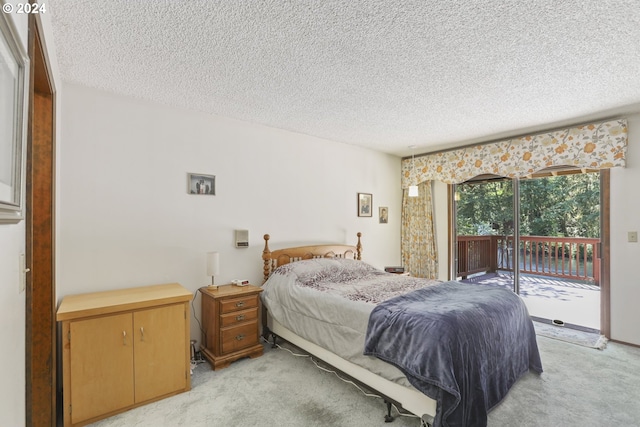 carpeted bedroom with a textured ceiling and access to exterior