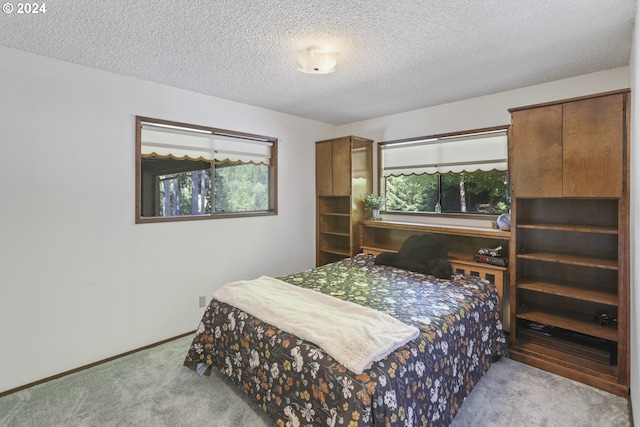 carpeted bedroom featuring a textured ceiling