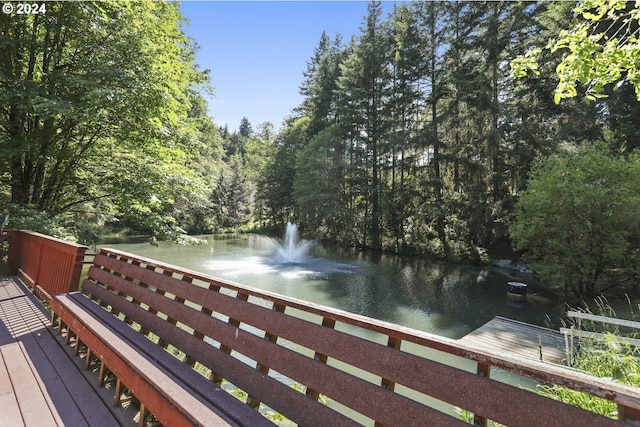 wooden deck featuring a water view