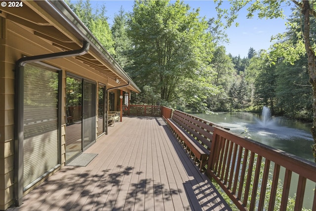 wooden deck featuring a water view