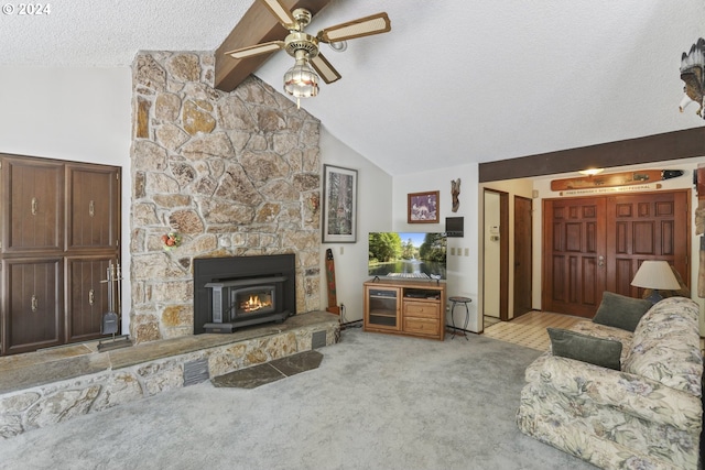 living room featuring high vaulted ceiling, a fireplace, a textured ceiling, carpet flooring, and ceiling fan