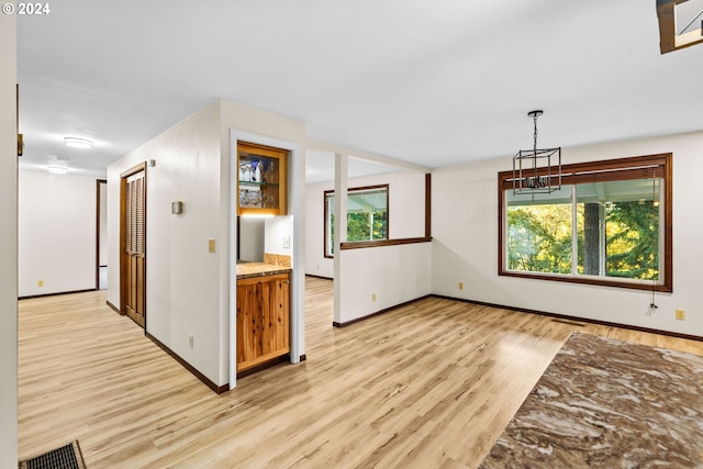 39145 Eagles Rest Rd, Dexter, OR 97431 - interior space with a chandelier, light wood-style flooring, baseboards, and a healthy amount of sunlight