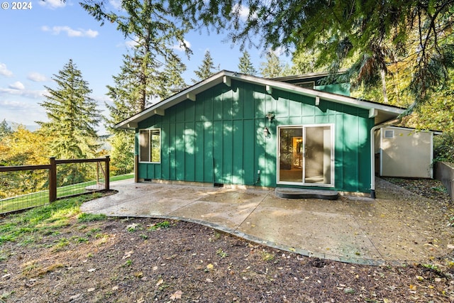 39145 Eagles Rest Rd, Dexter, OR 97431 - rear view of property featuring a patio area, fence, and board and batten siding