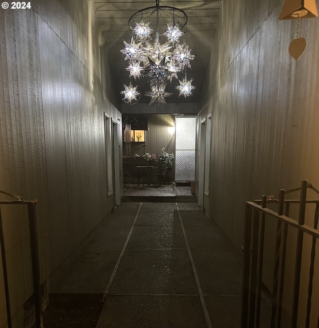 hallway featuring a chandelier