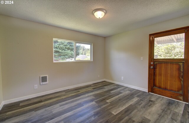 entrance foyer with dark hardwood / wood-style floors and a textured ceiling