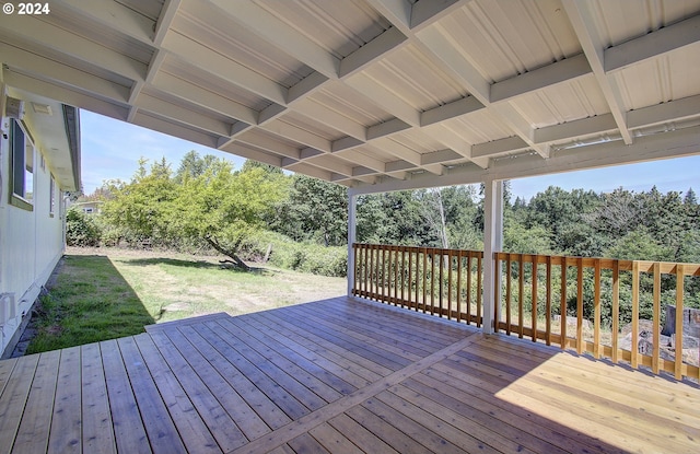 wooden terrace featuring a yard