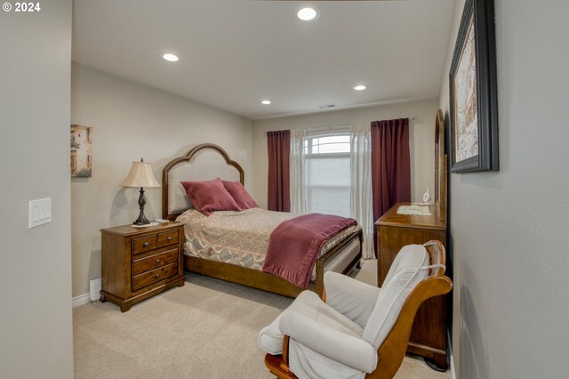 bedroom featuring light carpet