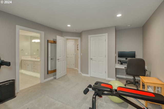 workout room with light colored carpet and sink