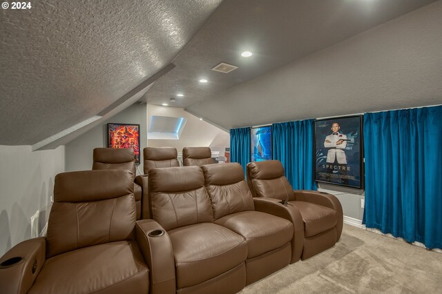 home theater featuring lofted ceiling, a textured ceiling, and carpet flooring