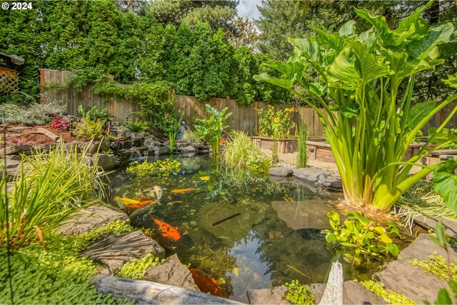 view of yard featuring a garden pond