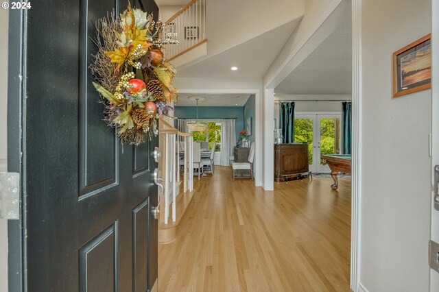 foyer entrance featuring billiards, hardwood / wood-style floors, and french doors