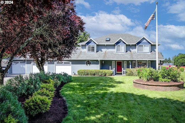 view of front of home featuring a front yard and a garage