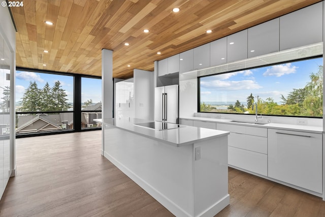 kitchen with white cabinetry, wood ceiling, light wood-type flooring, and high end fridge