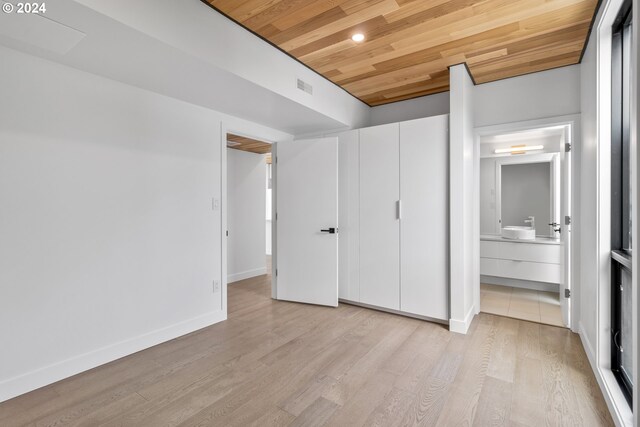 unfurnished bedroom featuring wood ceiling, light hardwood / wood-style flooring, and connected bathroom