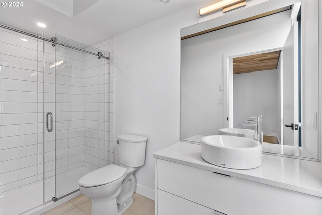 bathroom with vanity, toilet, tile patterned flooring, and an enclosed shower