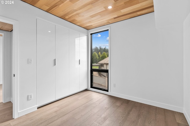 unfurnished bedroom featuring wood ceiling and light hardwood / wood-style floors