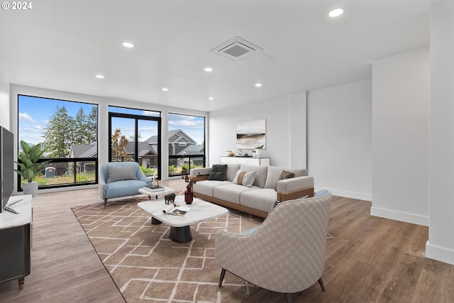 living room featuring expansive windows and light wood-type flooring