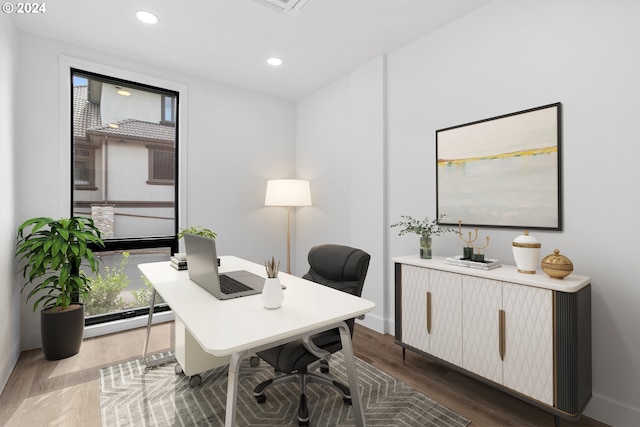 office space with a baseboard heating unit and hardwood / wood-style floors