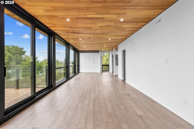 unfurnished sunroom with wood ceiling