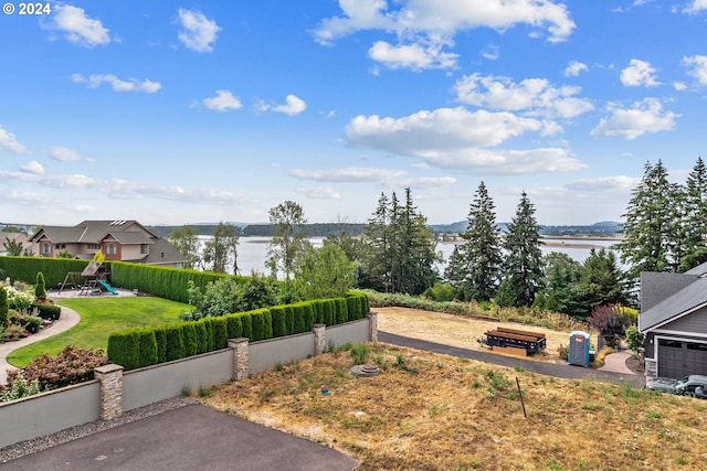 view of yard with a water view and a playground