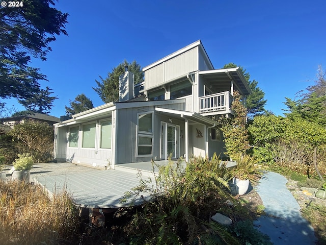 back of property with a balcony