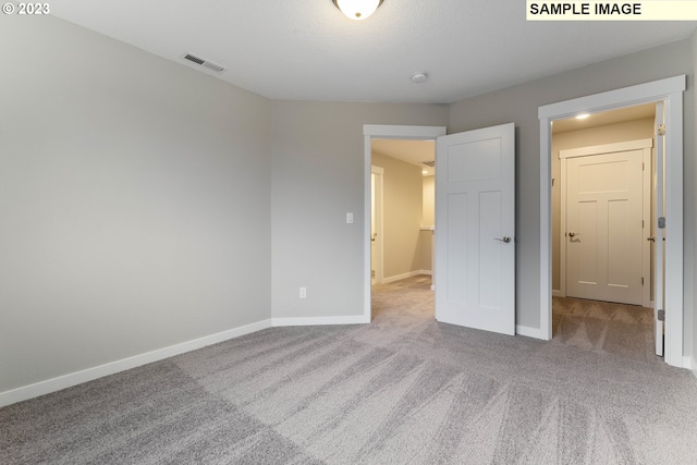 unfurnished bedroom with light colored carpet