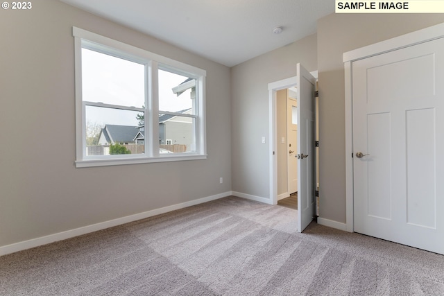 unfurnished bedroom with light carpet