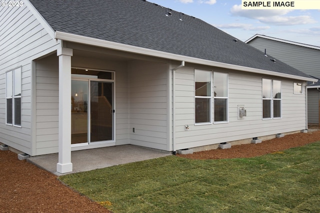 rear view of house featuring a yard and a patio