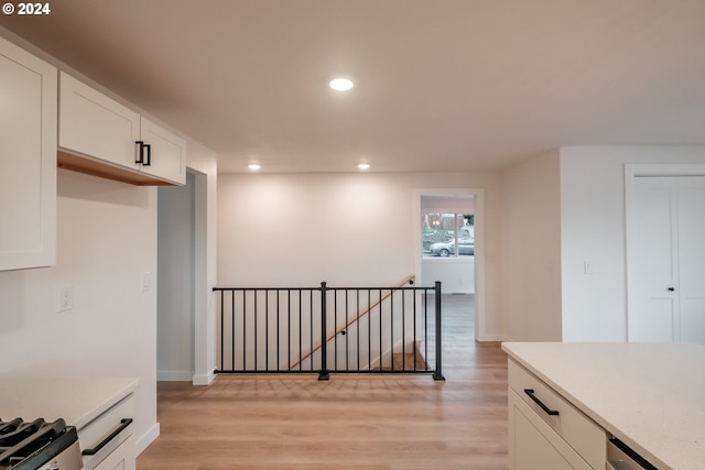 kitchen featuring white cabinets and light wood-type flooring