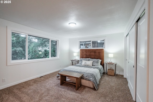 carpeted bedroom with a closet