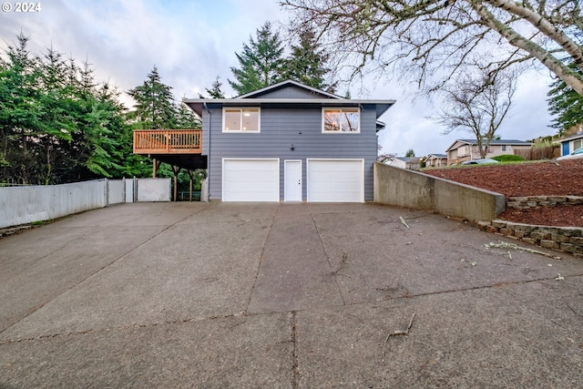 view of side of home with a garage and a wooden deck