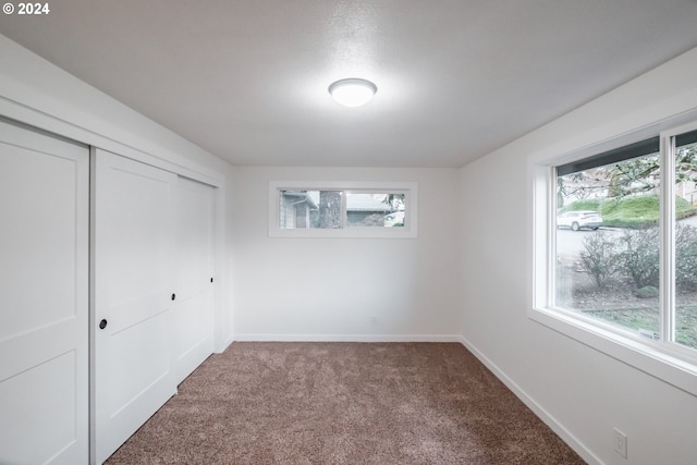 unfurnished bedroom with carpet flooring and a closet