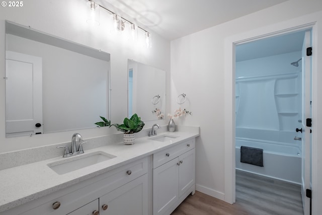 bathroom featuring hardwood / wood-style flooring, tub / shower combination, and vanity