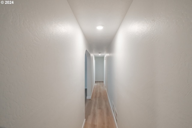 corridor with light wood-type flooring