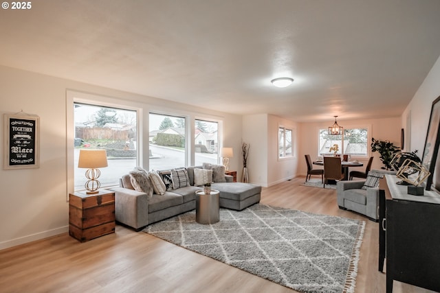 living room with wood-type flooring and an inviting chandelier