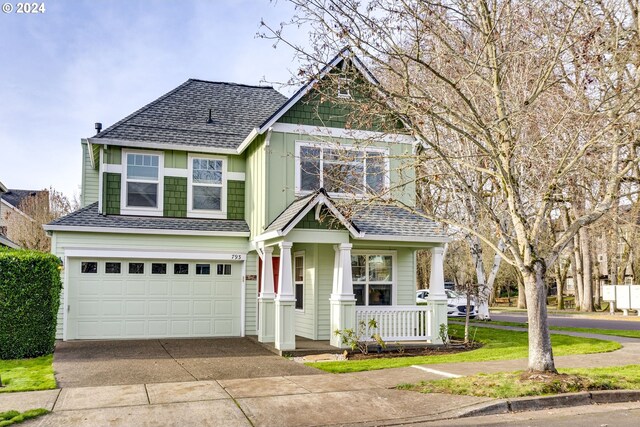 craftsman house featuring covered porch and a garage