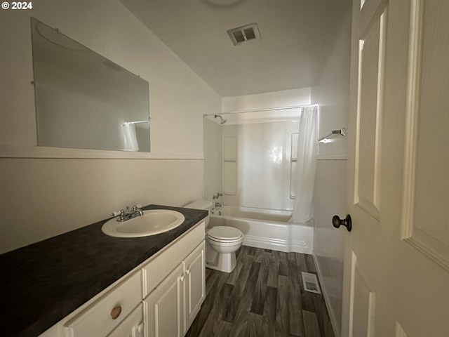 bathroom with toilet, shower / bathtub combination, vanity, and wood finished floors