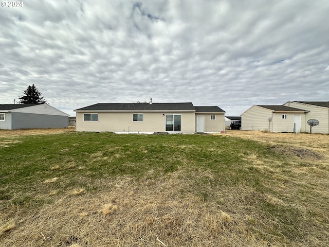 rear view of property with a lawn