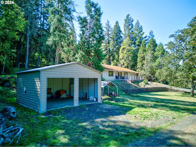 garage with a lawn and a carport