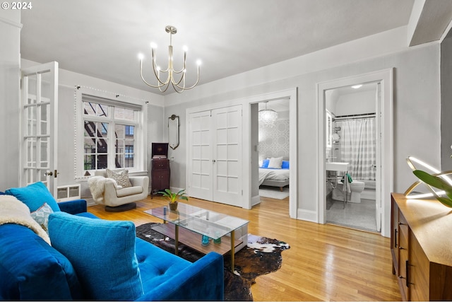 living room with wood-type flooring and an inviting chandelier