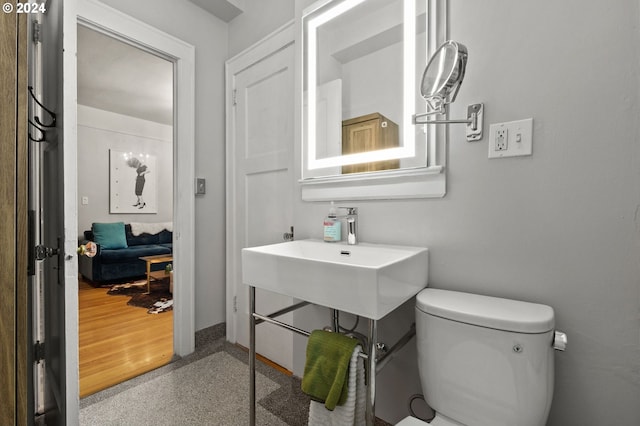 bathroom featuring hardwood / wood-style flooring and toilet