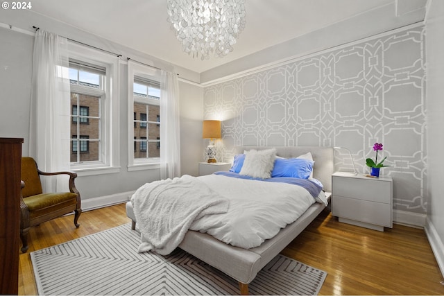 bedroom with a chandelier and wood-type flooring