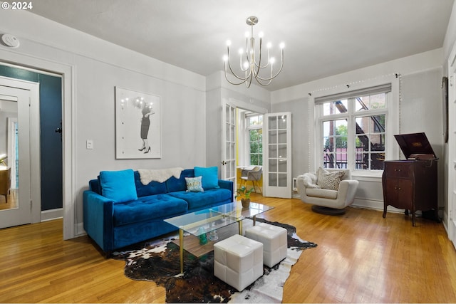 living room with an inviting chandelier and hardwood / wood-style floors