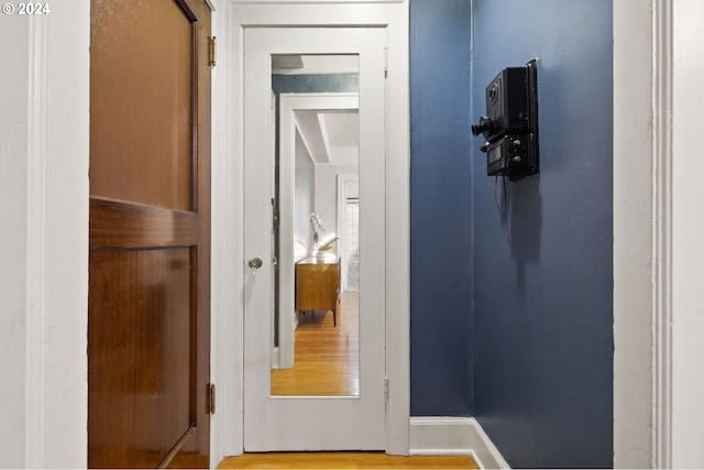 hallway with hardwood / wood-style floors