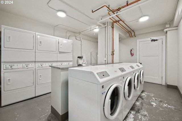 laundry area featuring stacked washer and clothes dryer and washing machine and dryer