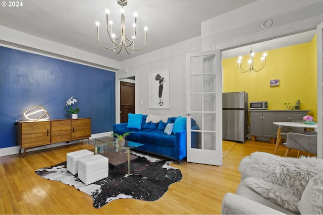 living room with wood-type flooring and an inviting chandelier