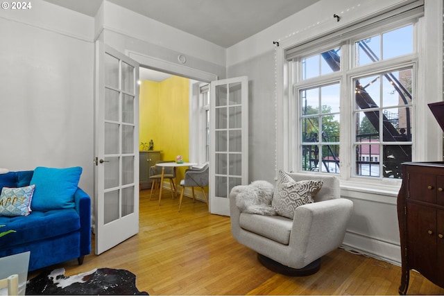 sitting room featuring french doors and light wood-type flooring