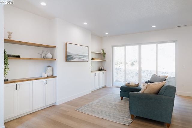 sitting room featuring baseboards, recessed lighting, visible vents, and light wood-style floors